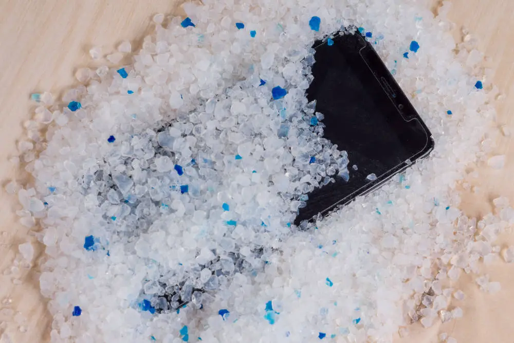 A mobile phone covered in Silica Gel after having been accidentally immersed in water.