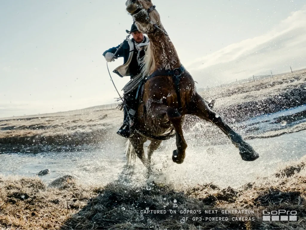 GoPro's GP3 Chip Targets Action Cameras' Biggest Weakness: Low Light 2 A photo of a horse rearing up with rider holding the reins, splashing in water, captured on GoPro's next generation GP3 powered camera.
